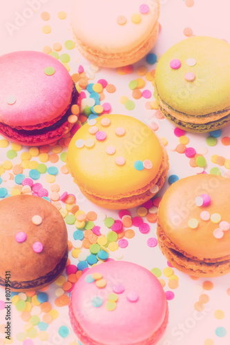 Sweet colorful macaroons against pink background. Top view