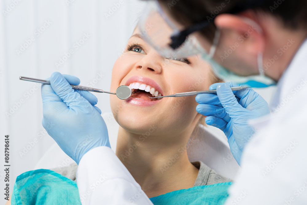 Regular dentist visit. Caries cure. Young woman visiting dentist - obrazy, fototapety, plakaty 
