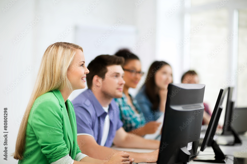 students with computers studying at school