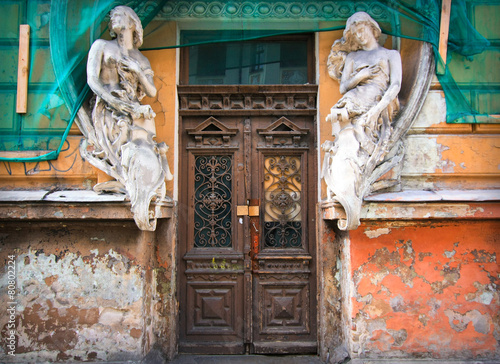 Restoration of the old abandoned house with statues of women