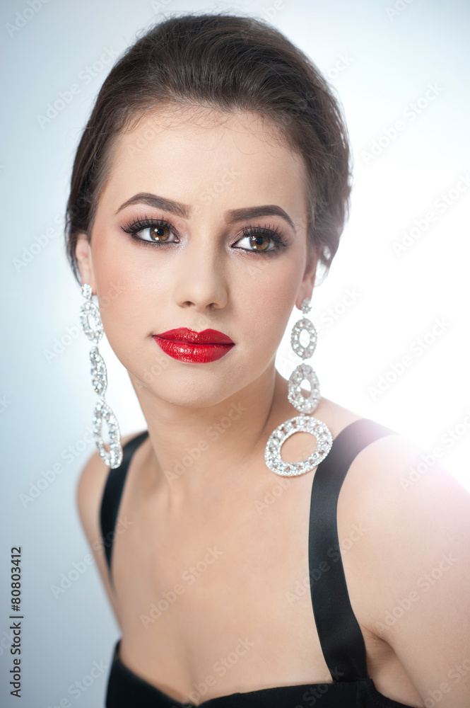 Hairstyle and make up - beautiful female with earrings, studio