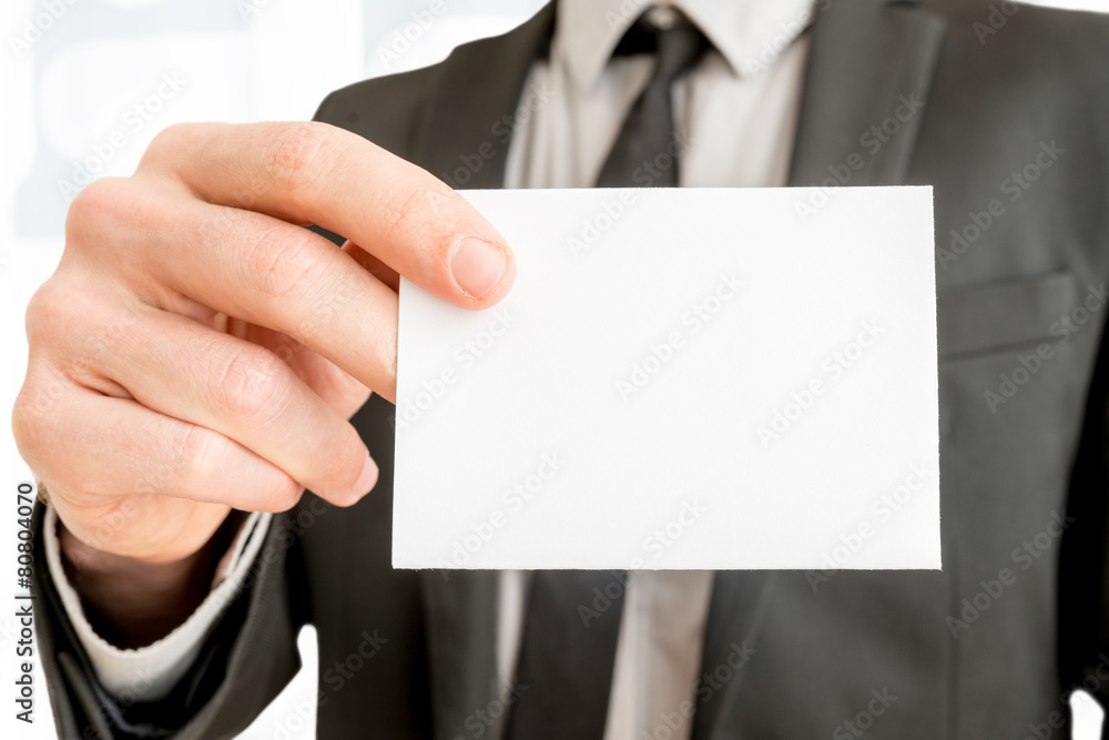 Closeup of businessman showing blank white business card Closeup of businessman showing blank white business card
