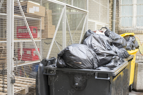 a lot of garbage in the street and container