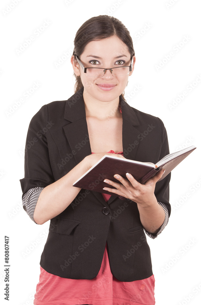 portrait of pretty female teacher wearing glasses and holding portrait of pretty female teacher wearing glasses and holding
