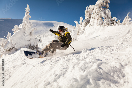 Snowboarder at jump photo