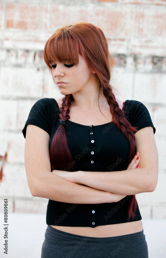 Rebellious teenager girl with red hair