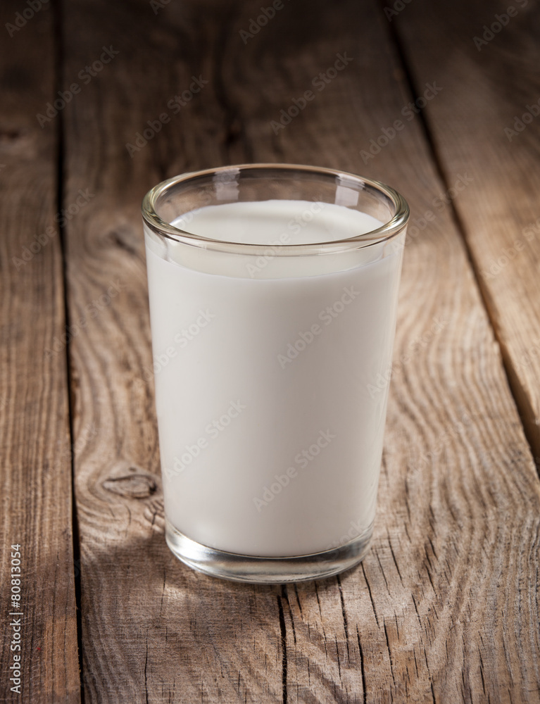 Fresh milk in a glass on old boards Fresh milk in a glass on old boards