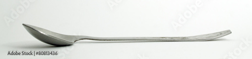Metal and wood spoon in profile