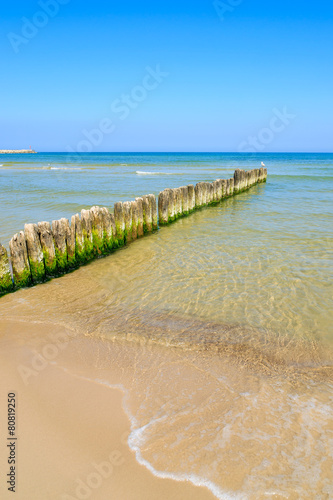 Wooden breakwater on beach in Ustka town, Baltic Sea, Poland