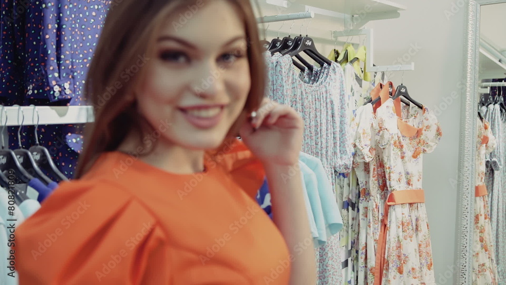Girl trying dress in looking in mirror cheerful and happy. Girl trying dress in looking in mirror cheerful and happy.