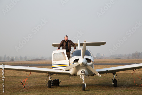 Pilot with the aircraft  after landing. photo