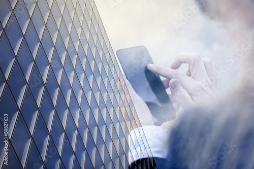 Business Women with smartphone with building background.
