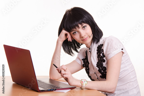 Call-center employee at desk rests his head on photo