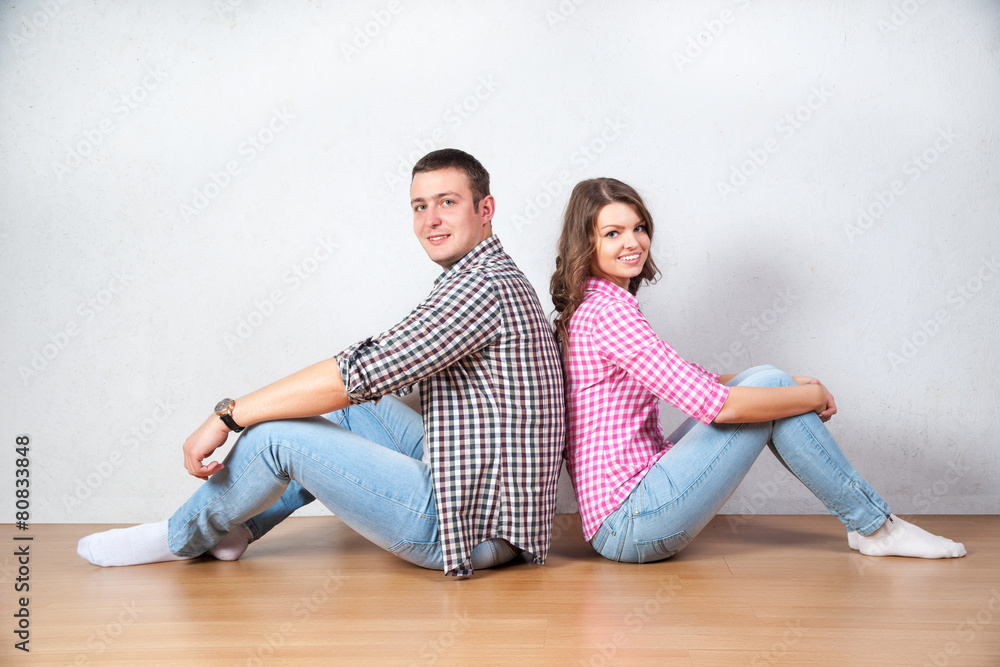 Young couple relaxing on the floor at home Young couple relaxing on the floor at home