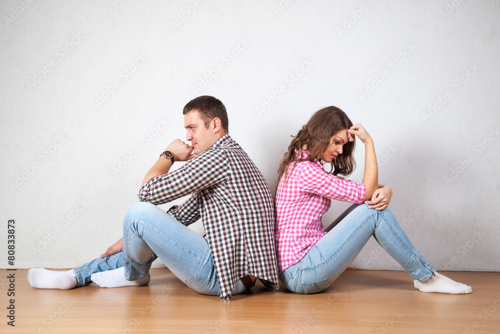 Couple sitting with their backs turned after having an argument Couple sitting with their backs turned after having an argument
