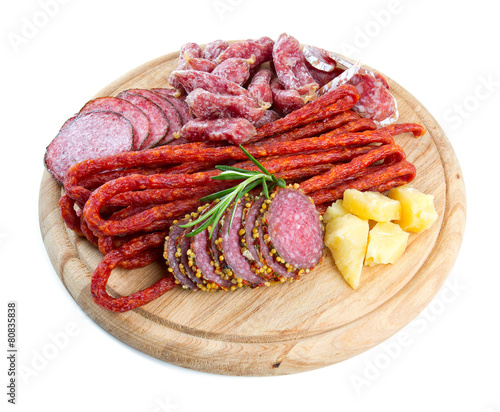 smoked salami, sausages and proschiutto isolated on white photo