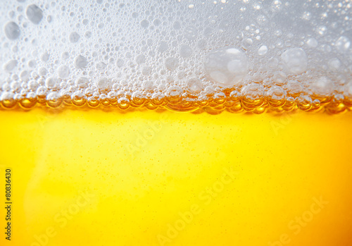 lots of bubbles floating in a drink with froth