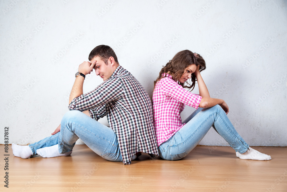 Couple sitting with their backs turned after having an argument Couple sitting with their backs turned after having an argument