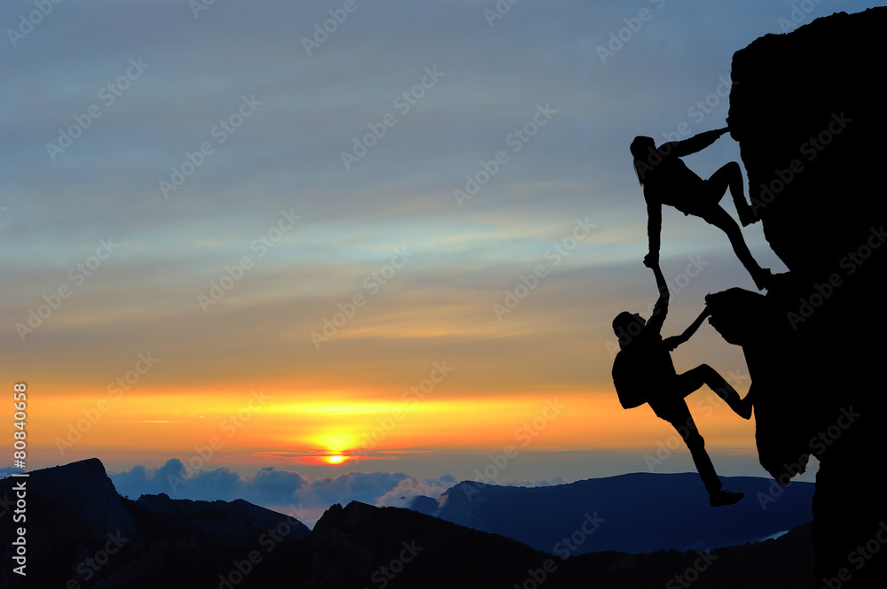 Teamwork of two people man and girl on mountain Teamwork of two people man and girl on mountain