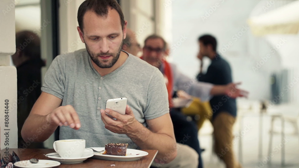 Young man taking photo of food with cellphone sitting in cafe Young man taking photo of food with cellphone sitting in cafe