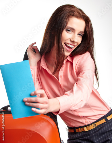 businesswoman with a suitcase and a ticket on a white background