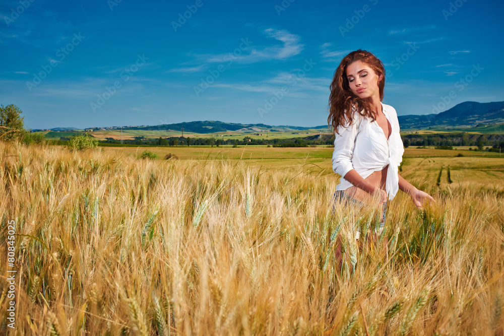 Portrait of a woman on golden cereal field in summer Portrait of a woman on golden cereal field in summer