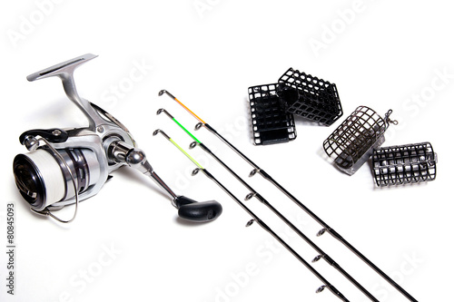 Fishing feeder and reel with accessories on white background
