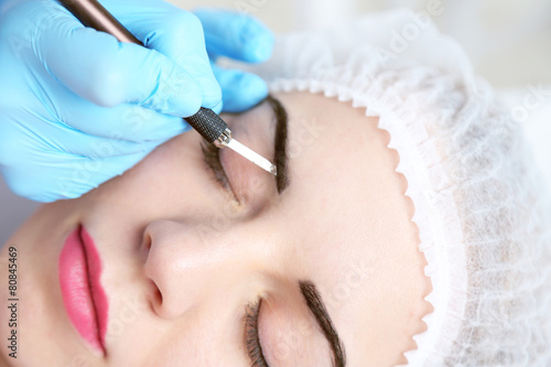 Cosmetologist applying perm...