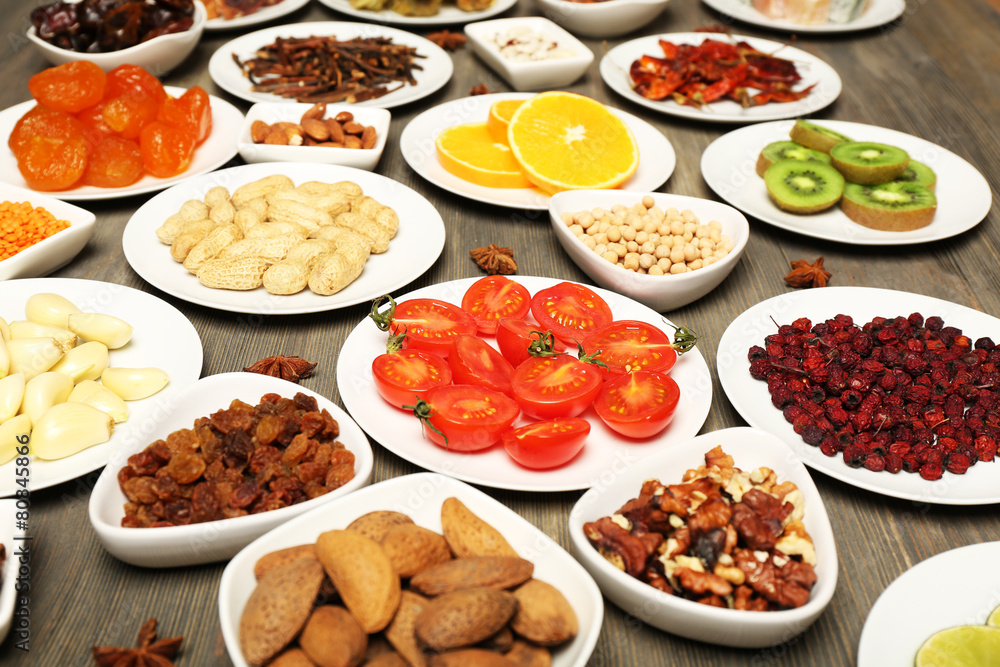 Different products on saucers on wooden table, closeup Different products on saucers on wooden table, closeup