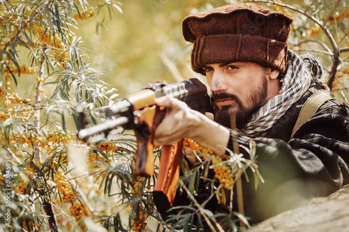 Portrait of serious middle eastern man with gun photo