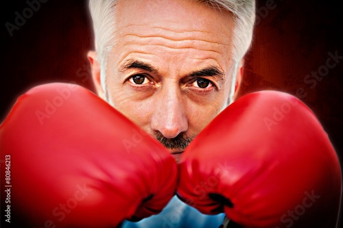 Close-up portrait of a determined senior boxe