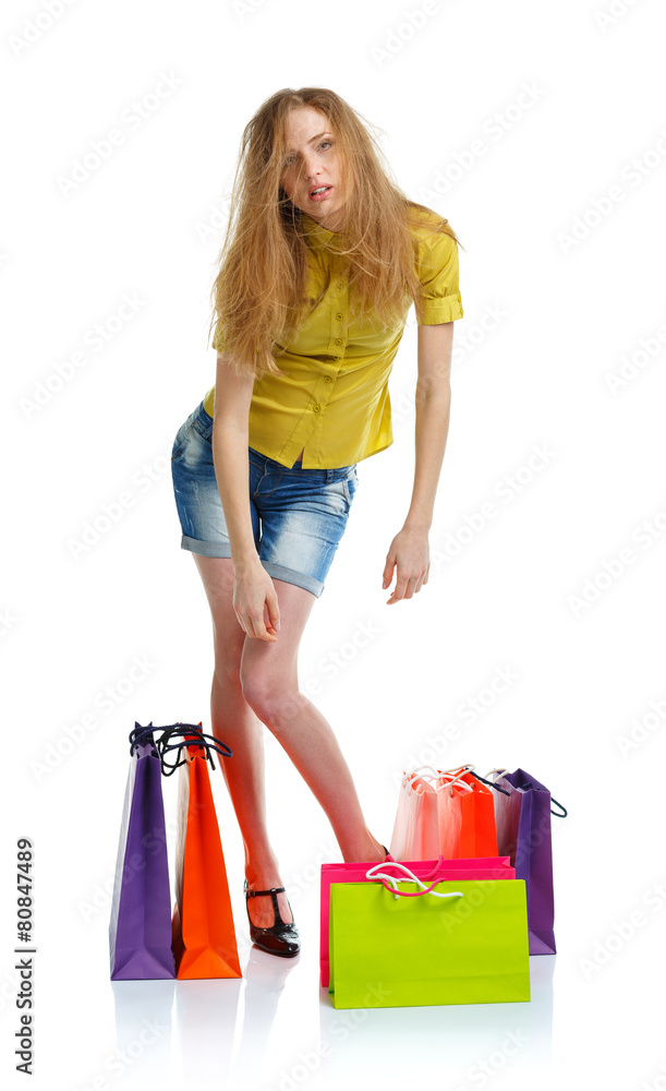 Happy lovely woman with shopping bags over white