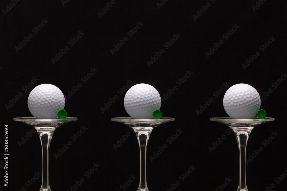 Three glasses of champagne and golf balls Three glasses of champagne and golf balls