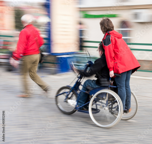 Fototapeta Naklejka Na Ścianę i Meble -  Man with disabilities in a wheelchair accompanied