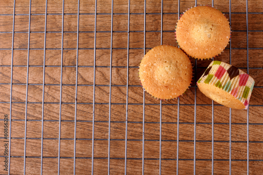 Freshly baked muffins served on cooling rack Freshly baked muffins served on cooling rack