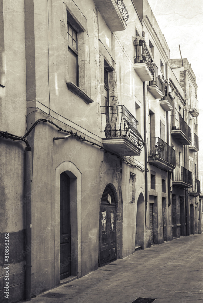 Narrow empty street view of Tarragona. Vintage stylized