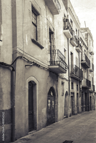 Narrow empty street view of Tarragona. Vintage stylized © evannovostro