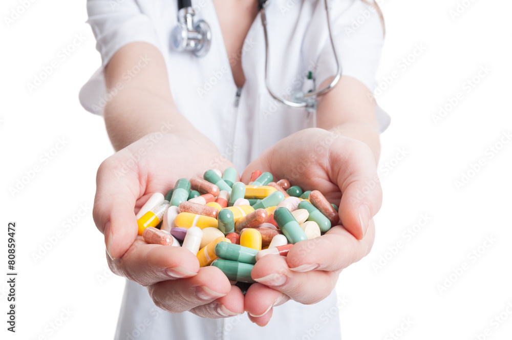 Woman doctor hands holding bunch of pills Woman doctor hands holding bunch of pills