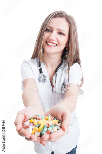 Young woman doctor offering pills