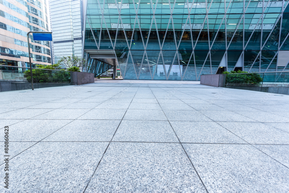 Empty pavement by the side of office building Empty pavement by the side of office building