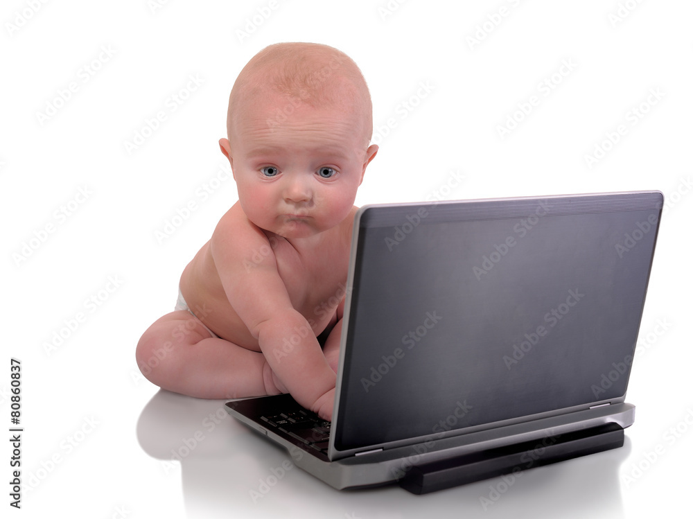 Baby boy with lap top staring at camera Baby boy with lap top staring at camera