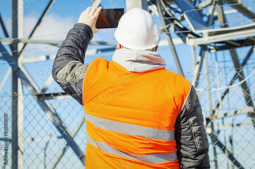 Engineer filmed with tablet PC at outdoors