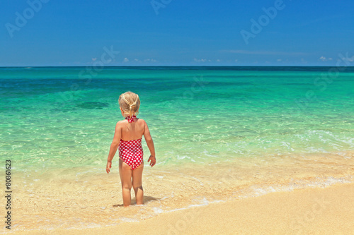 Girl standing on the sand beacn
