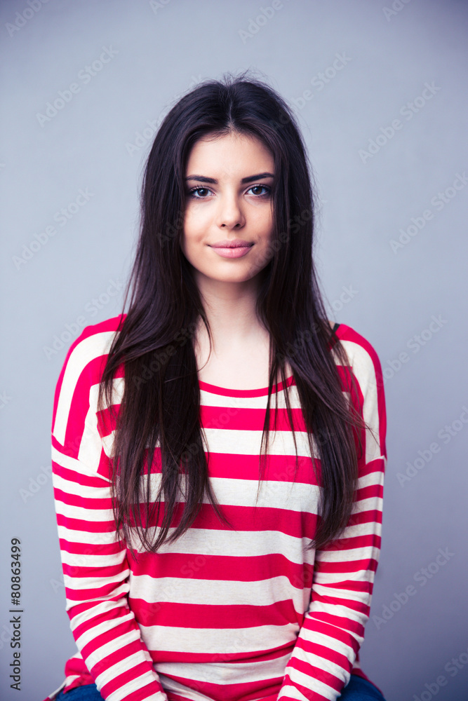 Portrait of a charming young woman over gray background Portrait of a charming young woman over gray background