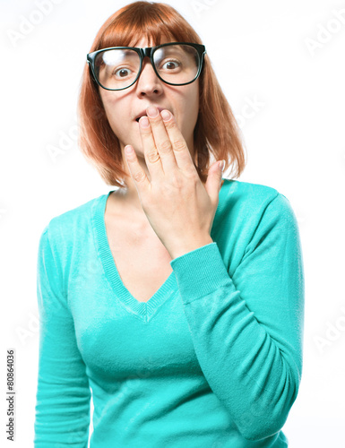 Redhead woman covering her mouth with her hand