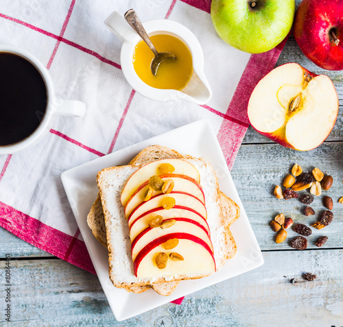 Toast with cheese, apple and dried fruit, a cup of coffee