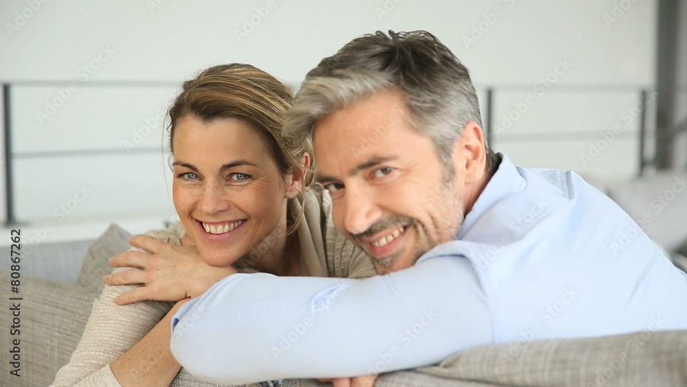 Portrait of mature couple relaxing in sofa Portrait of mature couple relaxing in sofa