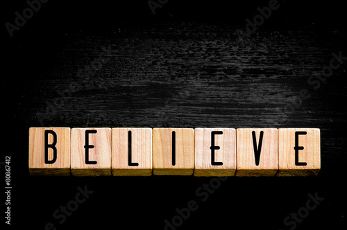 Word Believe isolated on black background