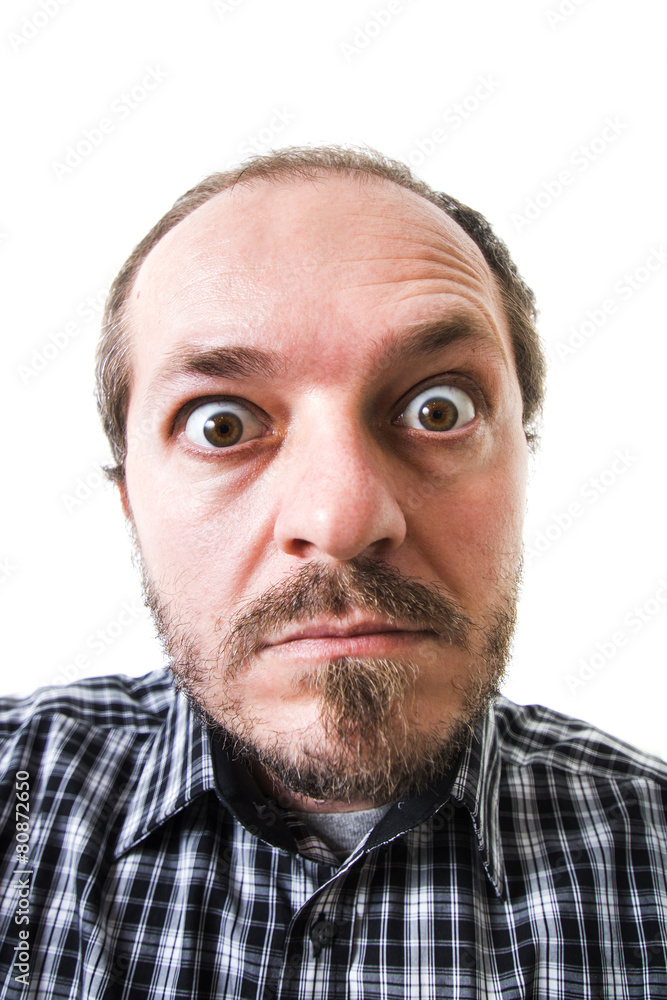 Obraz premium Surprised man in plaid shirt, eyes wide open