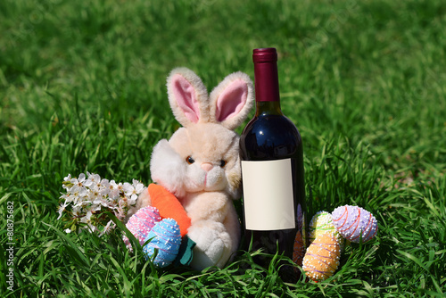 Row of Easter eggs red wine bottle rabbit in Grass